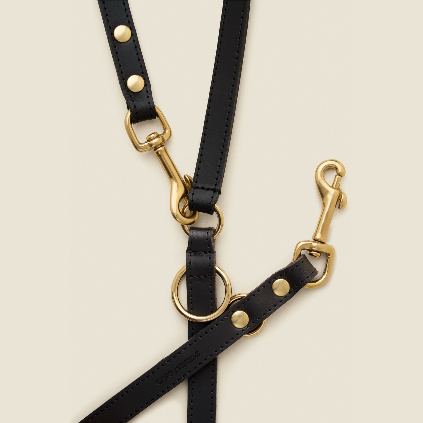 Adjustable black leather dog leash with gold hardware by Cano Ateliers