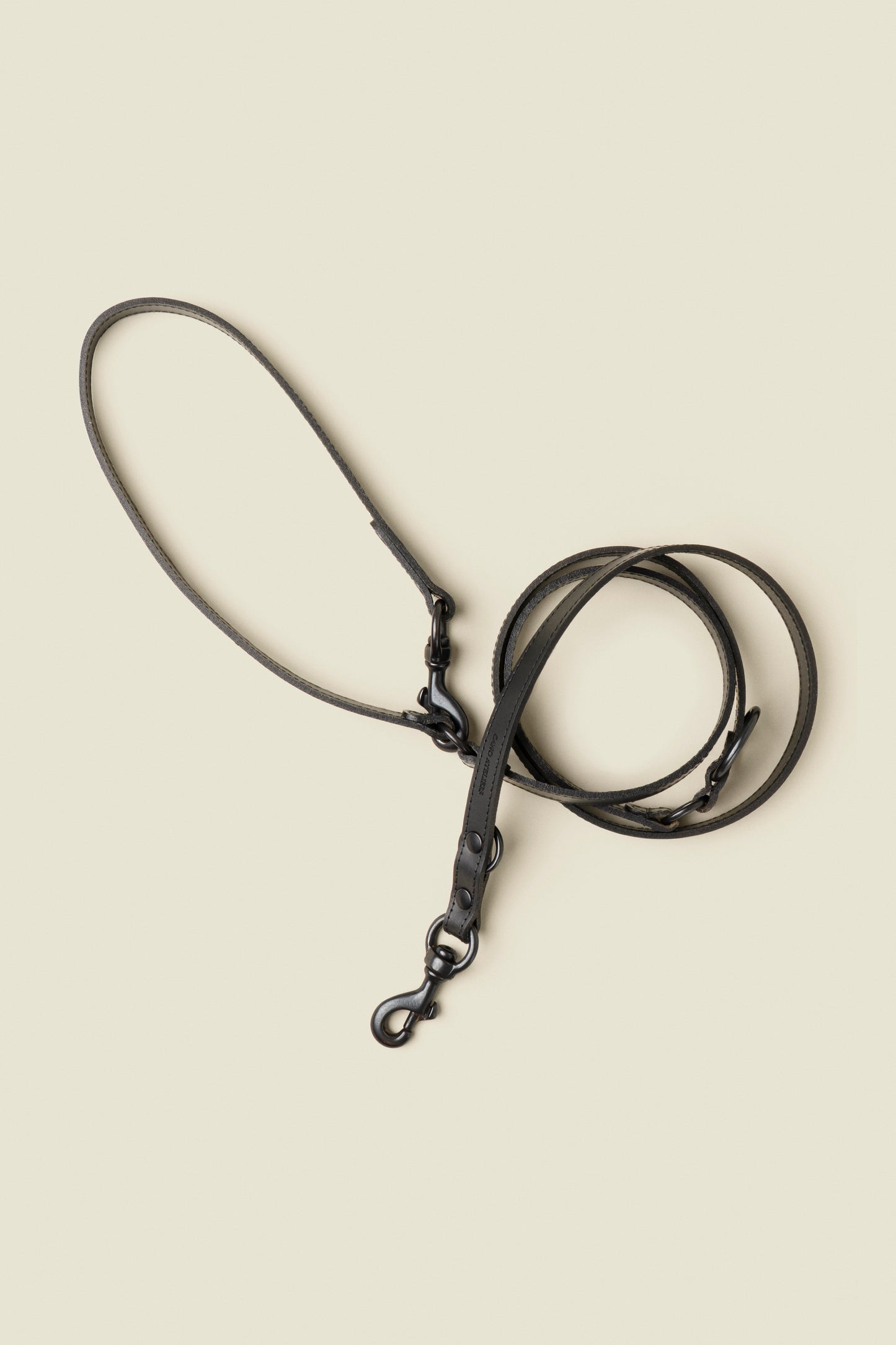 Adjustable black leather dog leash with matte black hardware by Cano Ateliers