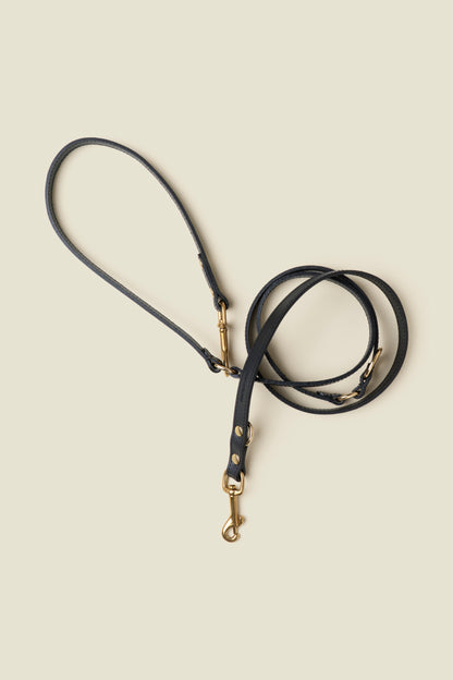 Adjustable black leather dog leash with gold hardware by Cano Ateliers