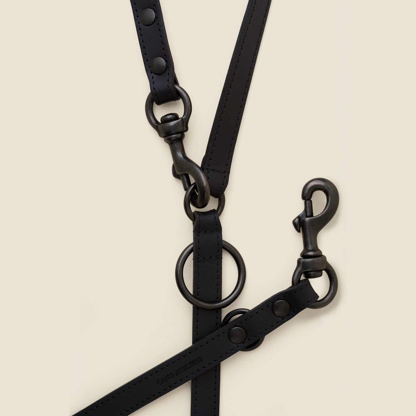 Adjustable black leather dog leash with matte black hardware by Cano Ateliers
