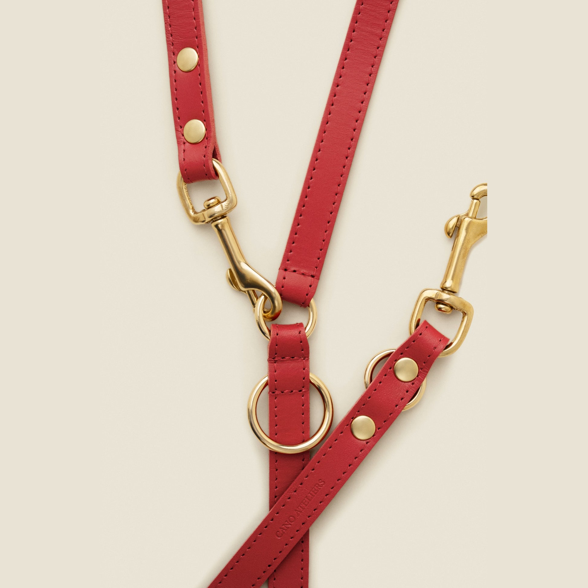 Adjustable red leather dog leash with gold hardware by Cano Ateliers
