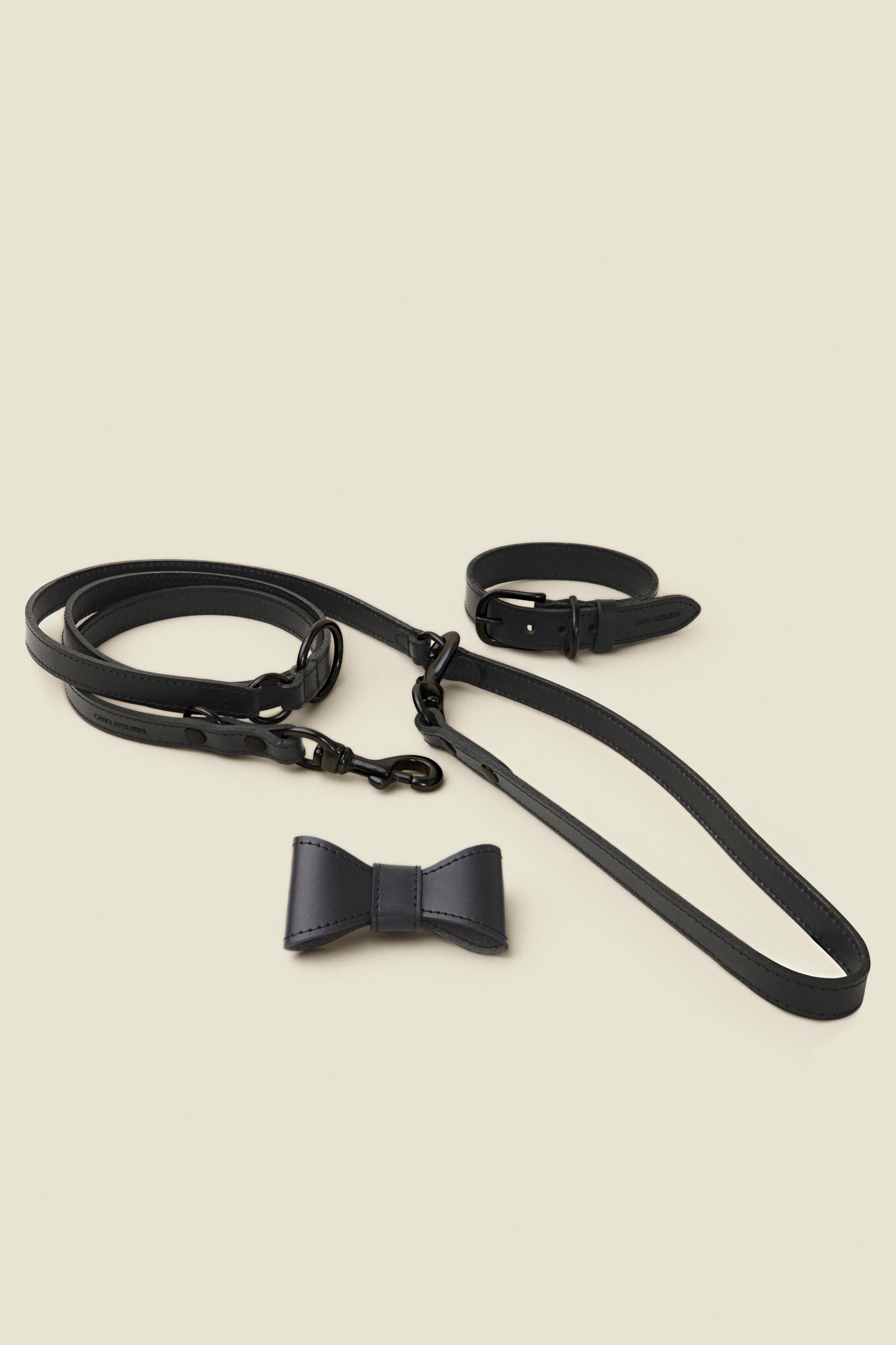 Matching black leather dog collar, leash and bowtie set by Cano Ateliers